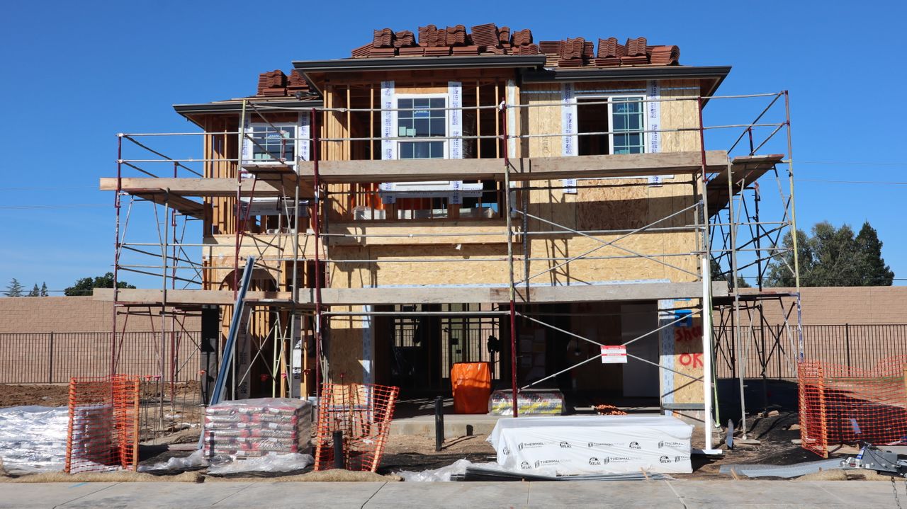 about-02 Construction underway for a new home in Elk Grove, California. Scaffolding and materials onsite.